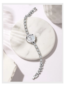 Vue macro montre GEDI quartz argentée avec maillons sertis de strass sur marbre blanc