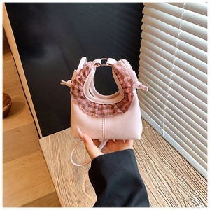 Pink mini crossbody bag featuring a brown plaid ruffle handle for children