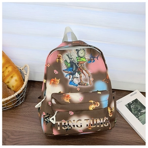 Detail of children's backpack with cartoon animal prints and sturdy top handle on a table