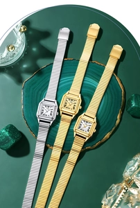 Three vintage square dial quartz watches with elastic metal bands on green agate stones