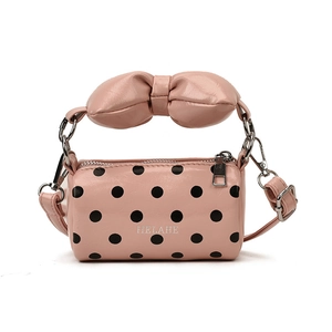 Pink polka dot cylinder mini bag with bow handle and adjustable shoulder strap