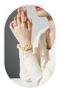 Detail of a vintage gold square quartz watch for women with woven chain strap on wrist
