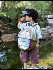 Detail of multi-color children backpack showing functional side pockets and adjustable straps