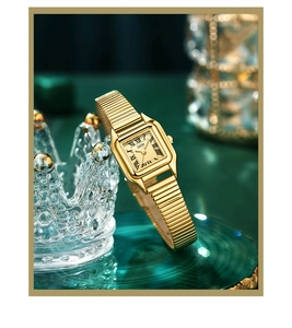 Close-up of golden square watch face with Roman numerals on a luxury velvet display
