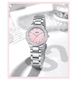 Macro detail of silver steel watch with pink dial and sparkling rhinestone bezel
