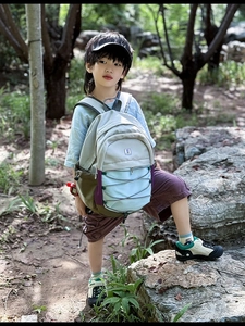 Detail of colorful outdoor kids backpack with adjustable cords and padded straps