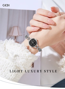 Close-up of GEDI luxury silver bracelet watch with black dial worn by female model