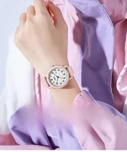 Close-up of pink quartz watch with silicone strap worn on wrist for trendy summer style