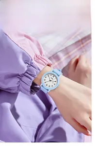 Close-up of light blue silicone strap watch with date display on a female wrist