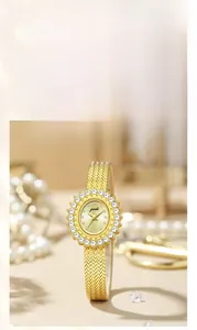 Close-up of golden sunray dial with diamond bezel and wheat-patterned metal watch strap