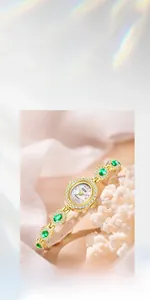 Detailed macro view of the oval mother-of-pearl dial and green gemstone bezel of the watch