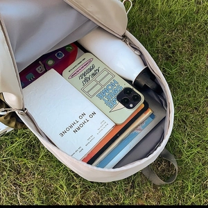 Lightweight cream backpack for kids featuring spacious interior with daily school essentials