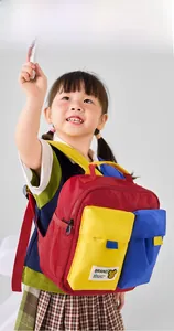 Detailed view of kids color-block backpack with vibrant red, yellow and blue nylon fabric