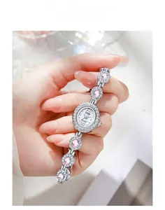Close-up of silver quartz watch with pink oval gemstones and sparkling zircon bezel