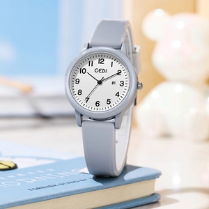 Minimalist quartz watch with blue silicone strap and date display on a clean background