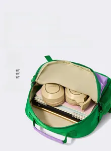 Internal view showing spacious compartments and waterproof fabric of the green school bag