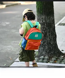 Outdoor shot of a child wearing the colorful multi-color backpack on a tree-lined path
