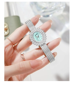 Detail of elegant silver watch with mint green mother-of-pearl dial and crystal bezel