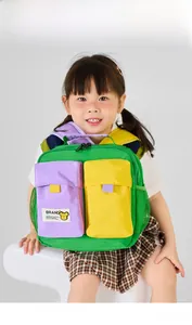 Detail of vibrant green nylon kids backpack with purple and yellow pockets and side mesh