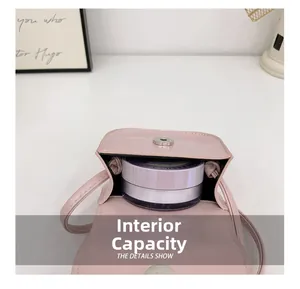 Internal capacity of pink PU leather mini crossbody bag holding a powder compact