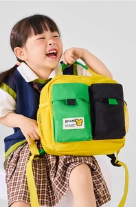 Toddler backpack with vibrant yellow and green color-blocking panels and mesh side pockets