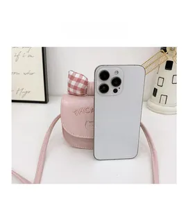 Detailed comparison of pink toddler crossbody bag size with a smartphone reference