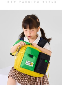 Detail of colorful preschool backpack with green pocket and yellow mesh side pockets