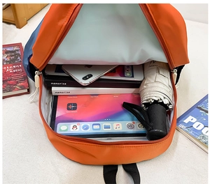 Interior view showing the large capacity of the color-block school backpack