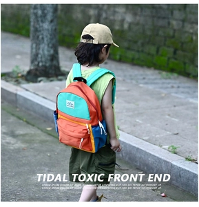 Outdoor view of children's ergonomic color-block backpack with padded shoulder straps