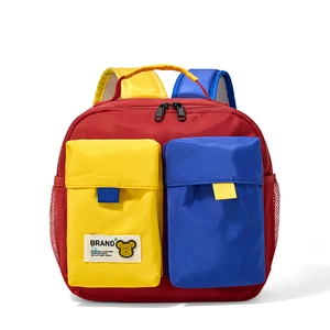 Detail of color-block kids backpack with cute cartoon bear pattern and soft fabric texture