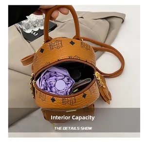 Internal capacity of brown printed mini backpack showing storage for a folding umbrella