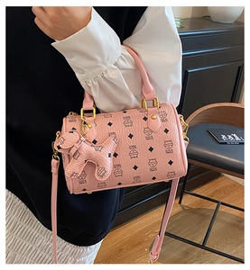 Pink boston bag with cat print pattern and cute puppy pendant on a minimalist background