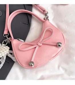 Pink mini crescent bag detail with leather bow, pearl charms and lace lace trim decoration