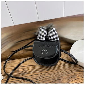 Detail of mini black cross-body bag for girls with plaid bow and cat embroidery