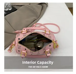 Pink cat print barrel bag showing large capacity for perfume, lipstick and sunglasses