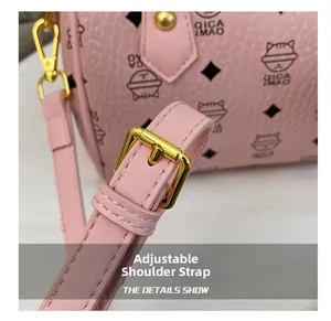 Detail of adjustable pink leather shoulder strap with gold buckle and neat stitching