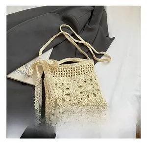 Close-up of beige crochet floral handbag with lace bow detail and woven textures