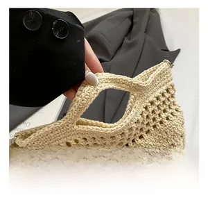 Macro detail of beige crochet hollow tote bag showing cutout handle and knit texture