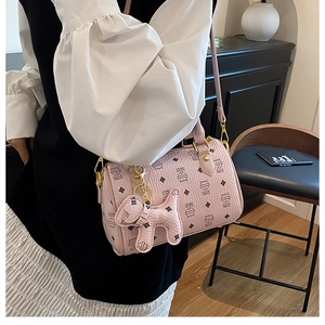 Pink Boston bag detail featuring cute cartoon cat prints and luxury puppy charm pendant