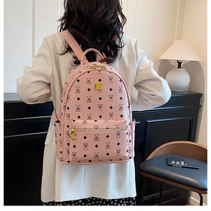 Detail of pink faux leather backpack with bear print and gold-toned metal hardware