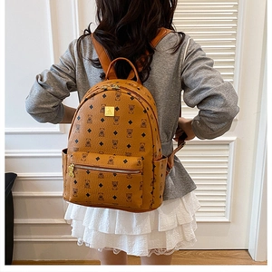 Detailed back view of a brown leather backpack with cute bear print and gold hardware