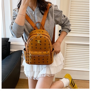 Close-up of brown backpack with cute bear prints, geometric patterns and gold zippers