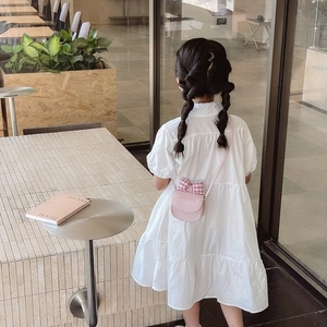 Pink kids crossbody bag with plaid bow on a white layered dress for a stylish look