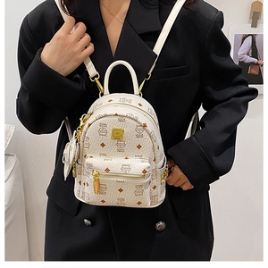 Mini cream-white PU leather backpack with brown cat print shown on model in black suit