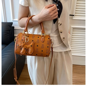 Detail view of the brown monogram Boston bag with golden rings and a cute puppy charm