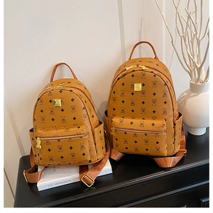 Detail showing two sizes of brown faux leather backpacks with cute bear and diamond prints