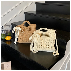 Detail of handmade woven straw bags featuring intricate lace bows and hollow patterns