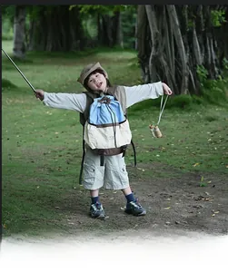 Outdoor setup featuring blue beige backpack and khaki utility vest for kids hiking