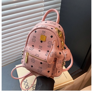Detail of pink mini backpack featuring cat print, lychee leather texture and gold hardware