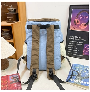 Detail of adjustable padded brown shoulder straps on a color-block kids backpack